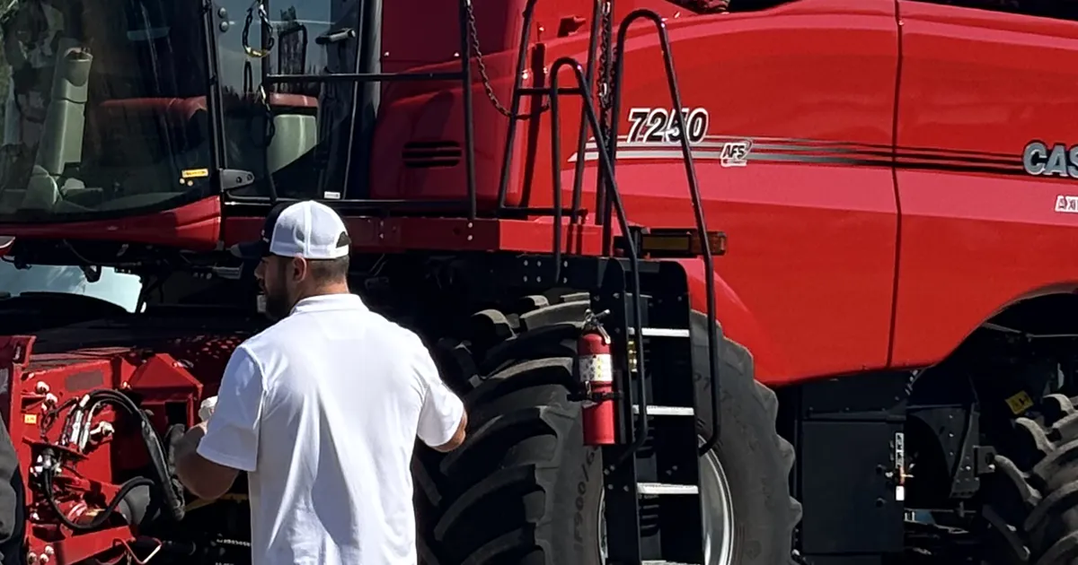farmer in front of combine